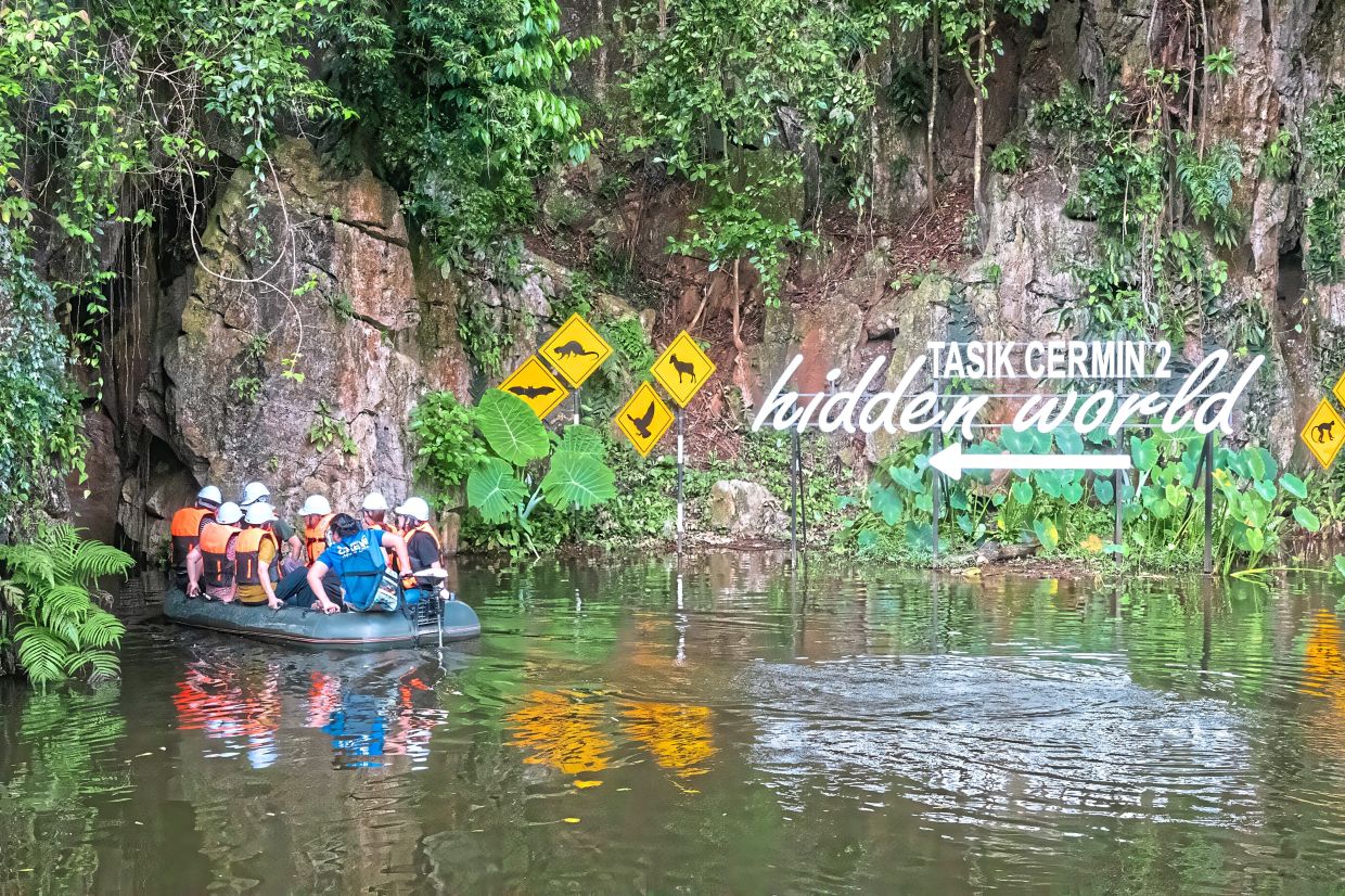 The entrance to Tasik Cermin 2 beckoning like a scene from a storybook, complete with jungle foliage, quirky animal signs and a promise of a “hidden world” beyond the rock wall.