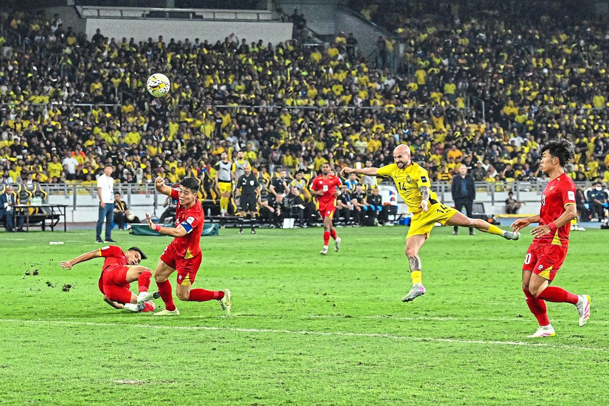 Opening the floodgates: Malaysia’s Joao Figueiredo scoring the first goal in their 4-0 win over Vietnam in the Asian Cup qualifier on June 10. — AFP