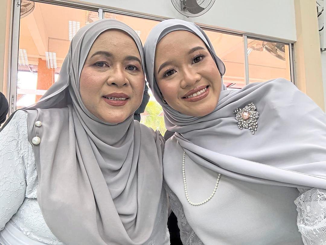 Noraini (left) with her youngest child Nur Aelissa Shafiya, 20, whom she says will inherit her tableware collections. — NORAINI MOHD NOOR