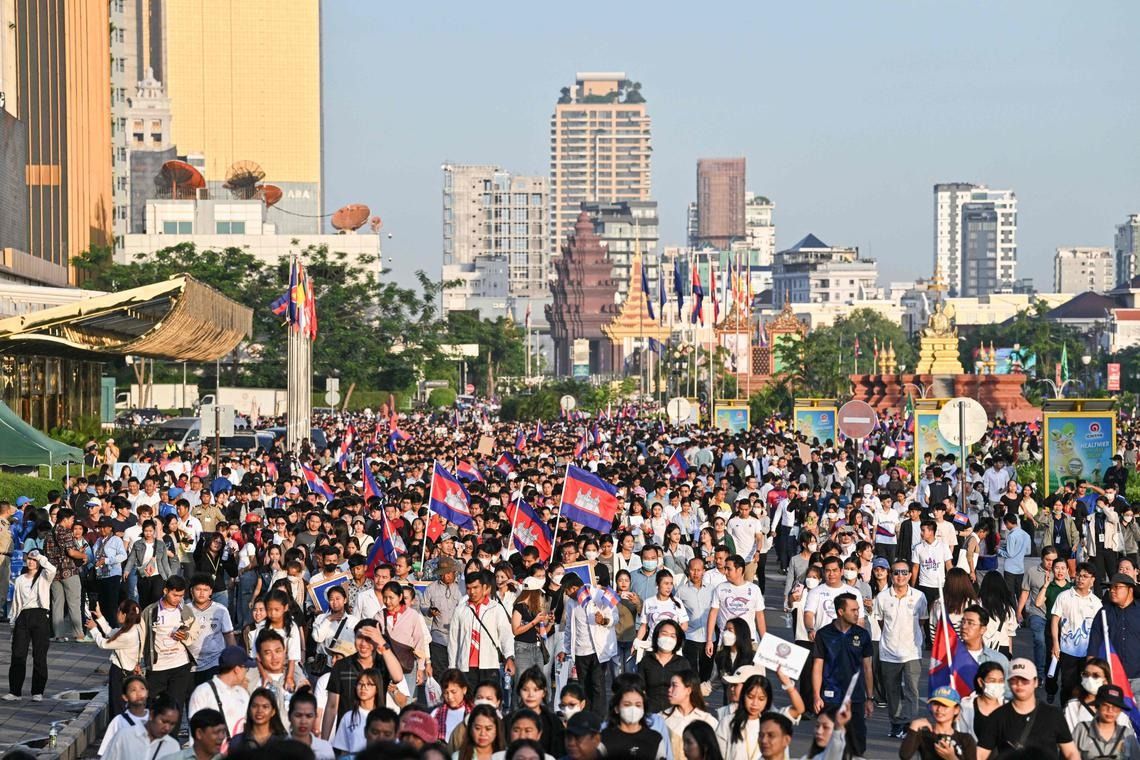 Carrying Cambodian flags and portraits of Mr Hun Manet and his father, former leader Hun Sen, supporters marched to the Independence Monument in the heart of the capital. - Photo: AFP