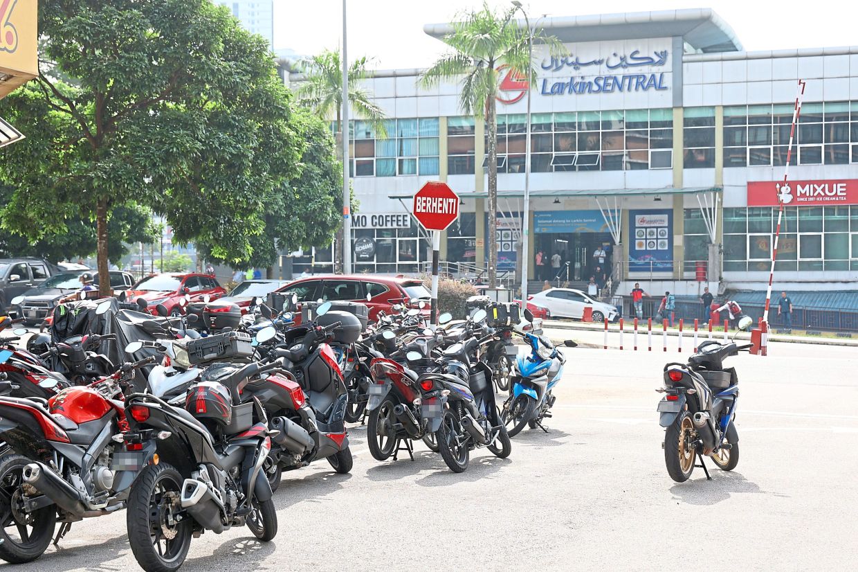 Motorcycles parked in a haphazard manner opposite Larkin Sentral Bus Terminal.