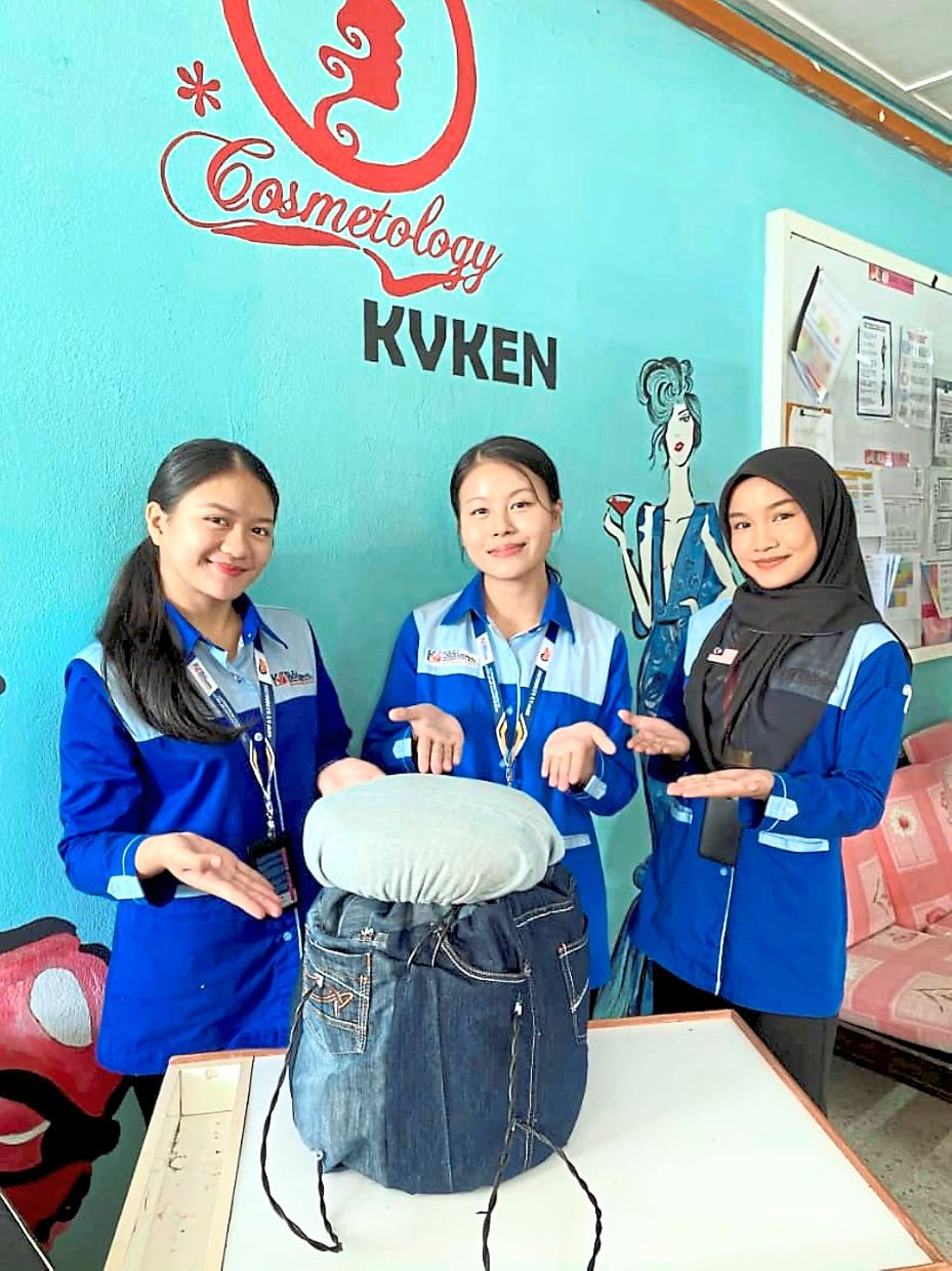 Jean-ius idea: (From left) Francis George, Benedict and Nur Nadia Natasya proudly displaying their award-winning upcycled chair.