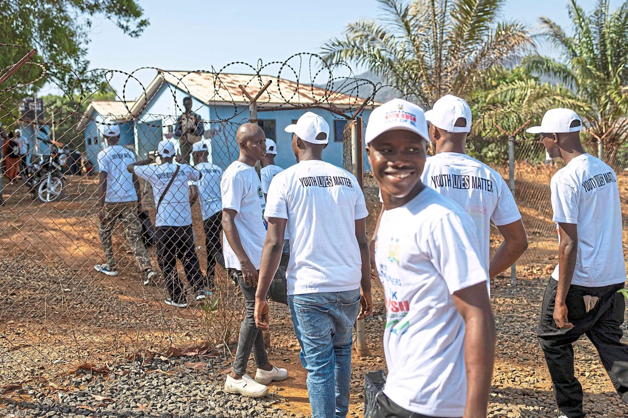 Patients wearing T-shirts with the words ‘Youth Lives Matter’ leaving a government-operated rehab centre after finishing their programme in the outskirts of Freetown. — AFP