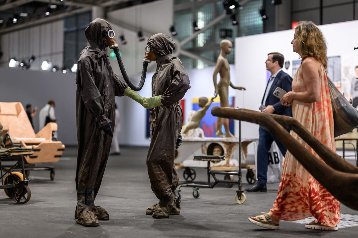 Visitors walk by the artwork 'The Voyage - A March To Utopia' (2022) by Dutch Atelier Van Lieshouton on display at the Unlimited section of Art Basel on June 17. Photo: AFP