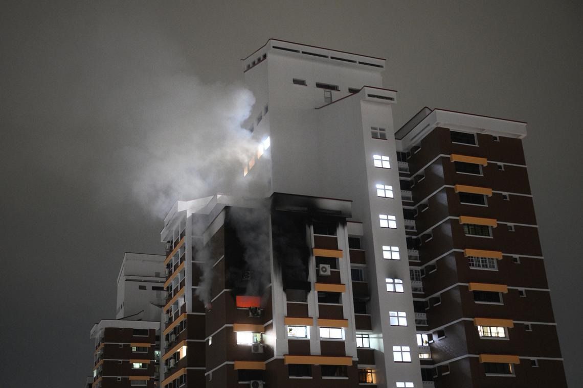 The fire being put out at Block 5 Holland Close on June 19. - Photo: ST