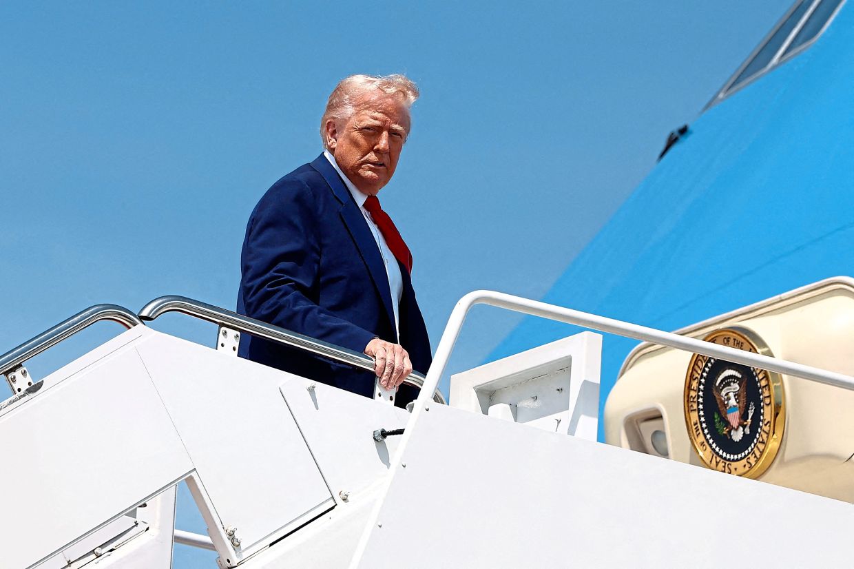 Trump boarding Air Force One as he departs for Michigan to attend a rally. — Reuters