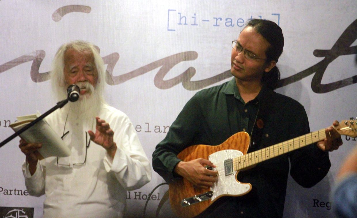 Samad at a poetry and music recital in George Town, Penang in November 2016, accompanied by his son Az on guitar. Photo: The Star/Filepic 