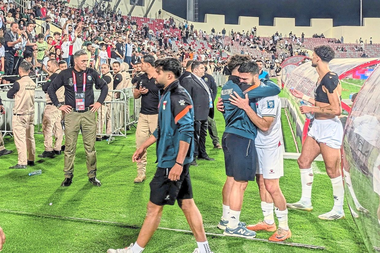 Palestinian players leave the field after an Asian Group B World Cup qualifying soccer match against Oman at the King Abdullah II Stadium in Amman, Jordan on June 12, 2025. (AP Photo/John Duerden)