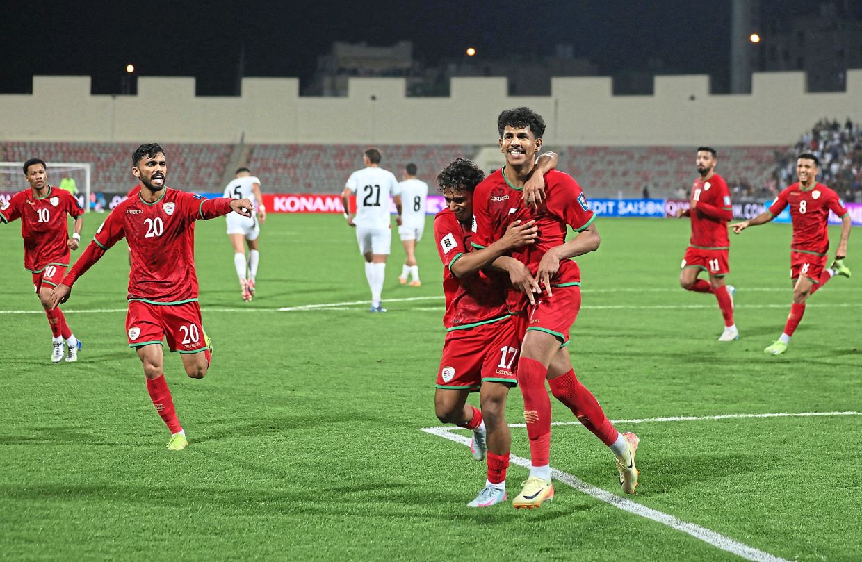 Oman’s Essam Al-Subhi celebrates after scoring the penalty to tie the score at 1-1. — Reuters