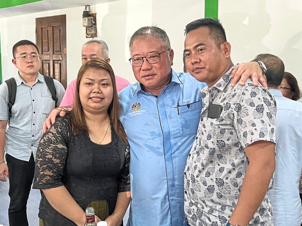 Tiong (in blue) with two longhouse residents during his Gawai visit.