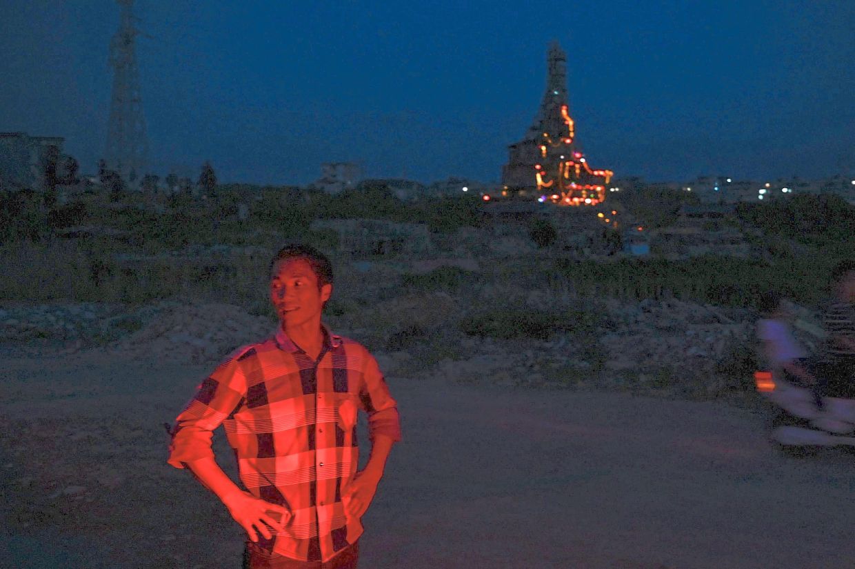Chen, with his house in the background.