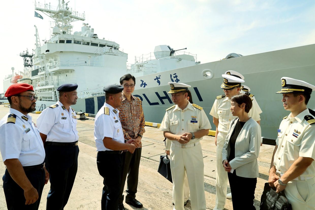 Japan Coast Guard (JCG) patrol vessel Mizuho safely docked at Port Klang Cruise Terminal, while (third from left) MMEA acting deputy director-general (Operations) Rear Admiral Mohd Zawawi Abdullah speaks to Japanese ambassador to Malaysia, Shikata Noriyuki (fourth from left) and JCG deputy commander (Operations) vice admiral Kanosue Hiroaki while others look on. — KK SHAM/The Star