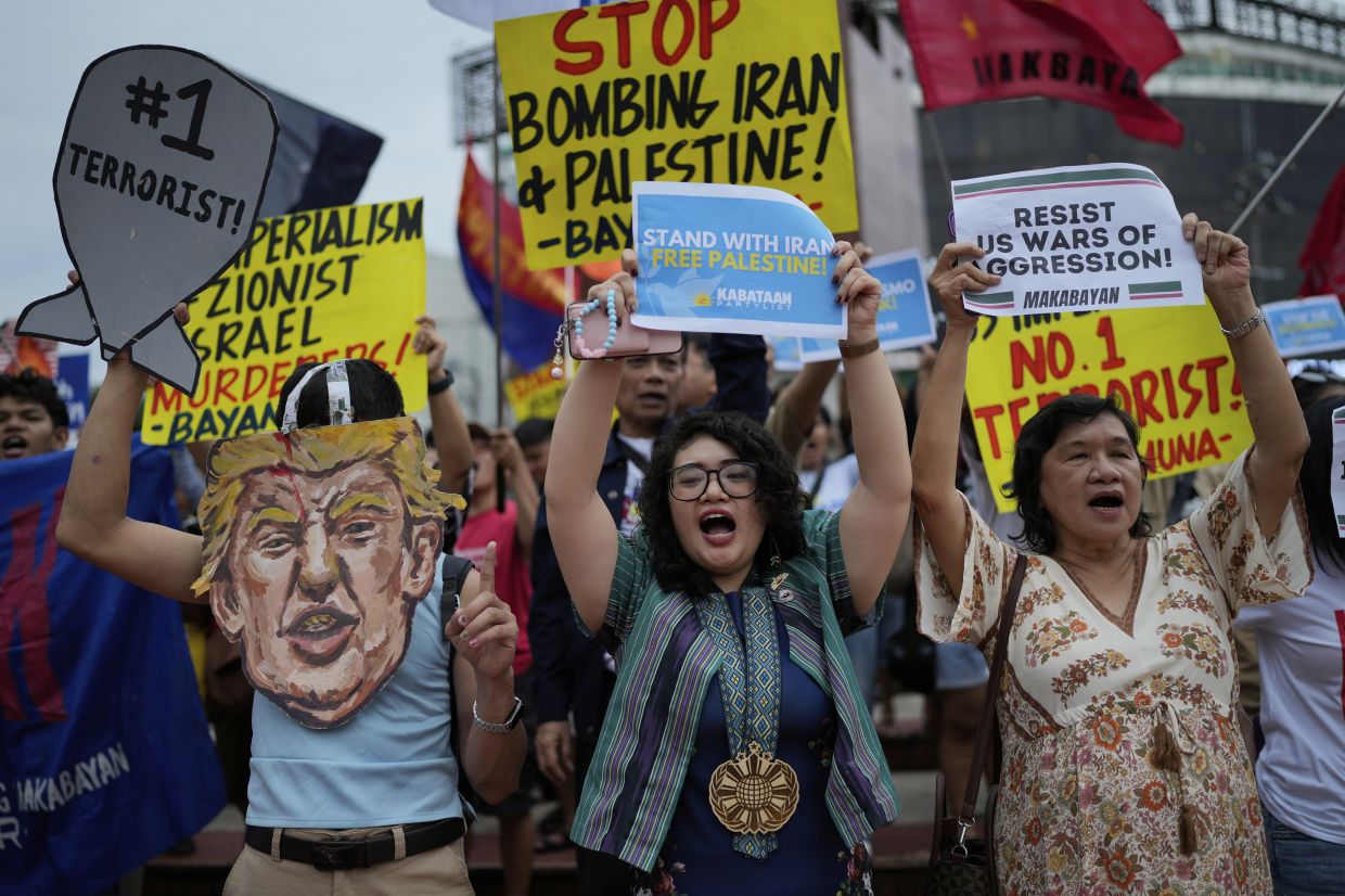Protesters shout slogans as they condemn the recent bombings of the US against Iran during a rally in Quezon city, Philippines. -- AP Photo/Aaron Favila