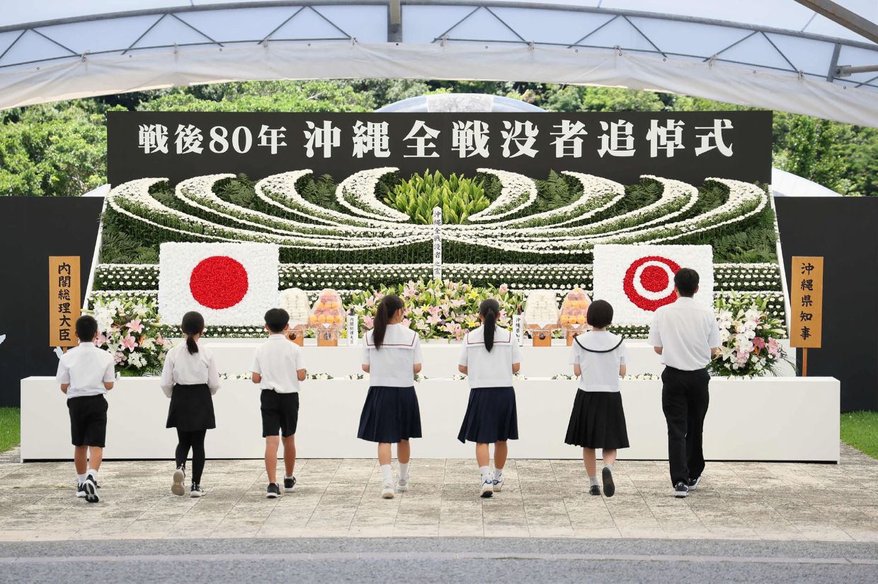 School children prepare to lay flowers at a memorial to those who died to mark the 80th anniversary of the Battle of Okinawa, at the Peace Memorial Park in Itoman, Okinawa Prefecture on Monday, June 23, 2025. The three-month battle, often dubbed the -- Typhoon of Steel --, killed about 200,000 people, almost half of them local civilians. - Photo by JIJI Press / AFP