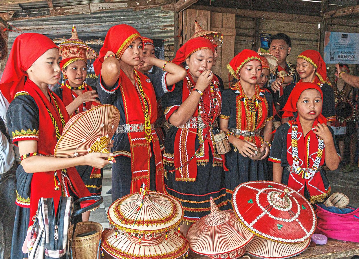 Villagers getting ready for the annual Gawai parade at Kampung Taee.- ZULAZHAR SHEBLEE/The Star