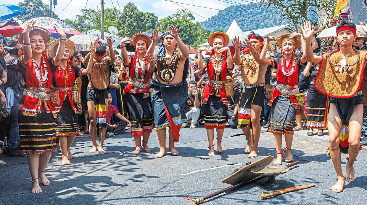 Villagers performing a traditional dance during the Gawai parade. - ZULAZHAR SHEBLEE/The Star