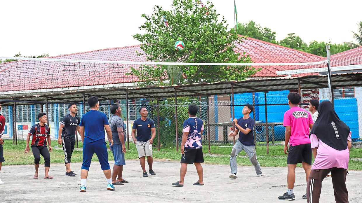 Villagers of Kampung Keniogan gather for an evening volleyball match, one of the few activities that has brought the community closer during their three-week Internet blackout.