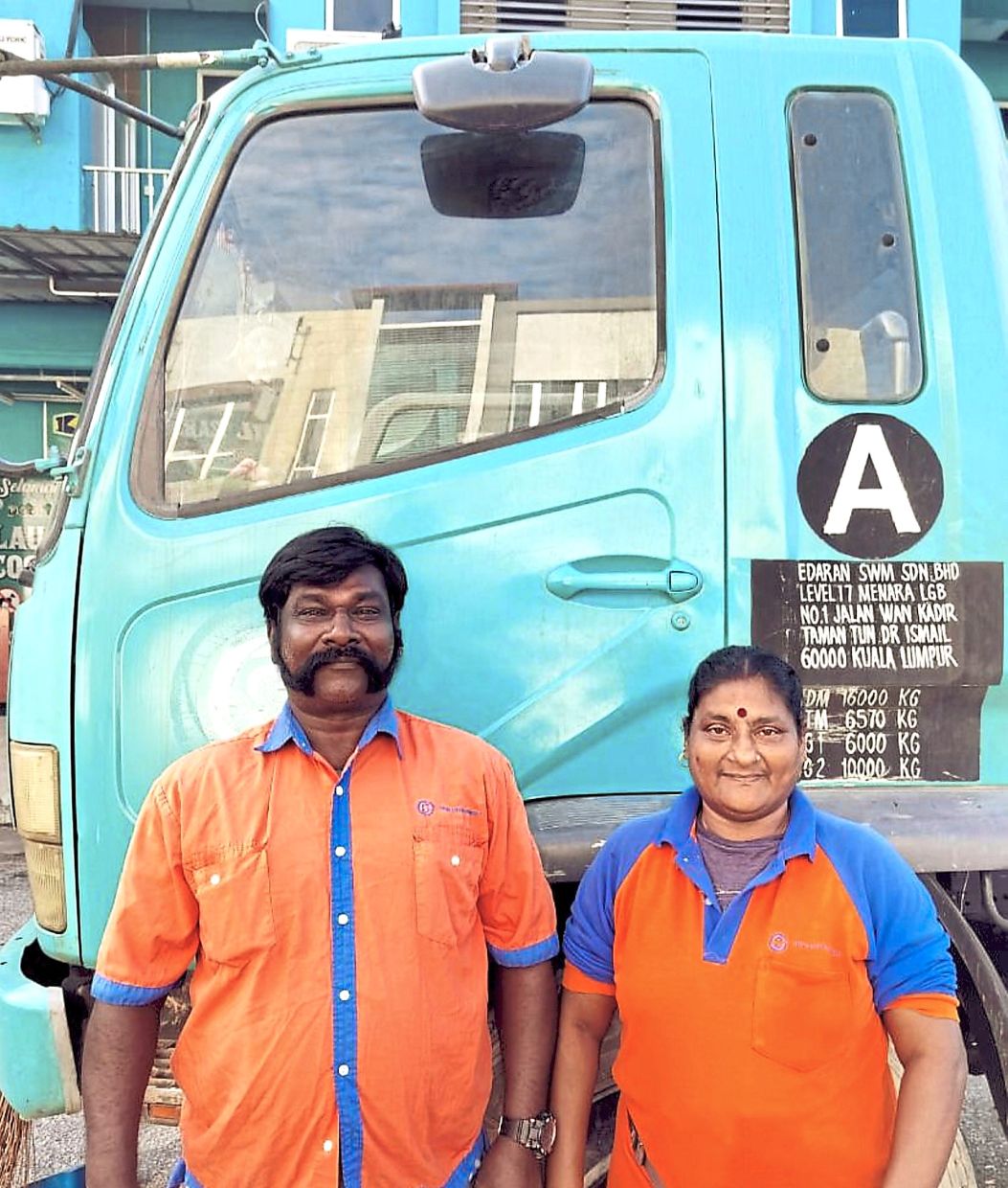 Family affair: Moses and Tanggam have been working in public sanitisation for over two decades.