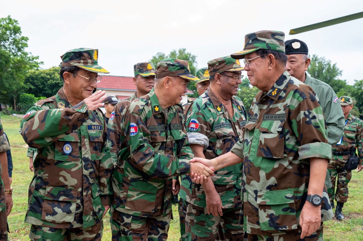 Cambodia's former Prime Minister Hun Sen is welcomed upon his visit at the Cambodian Armed Forces who stationed along the Cambodia-Thailand border, citing security concerns as tensions simmer over a long-standing border dispute, in Oddar Meanchey province, Cambodia. Agence Kampuchea Press/Handout via REUTERS 