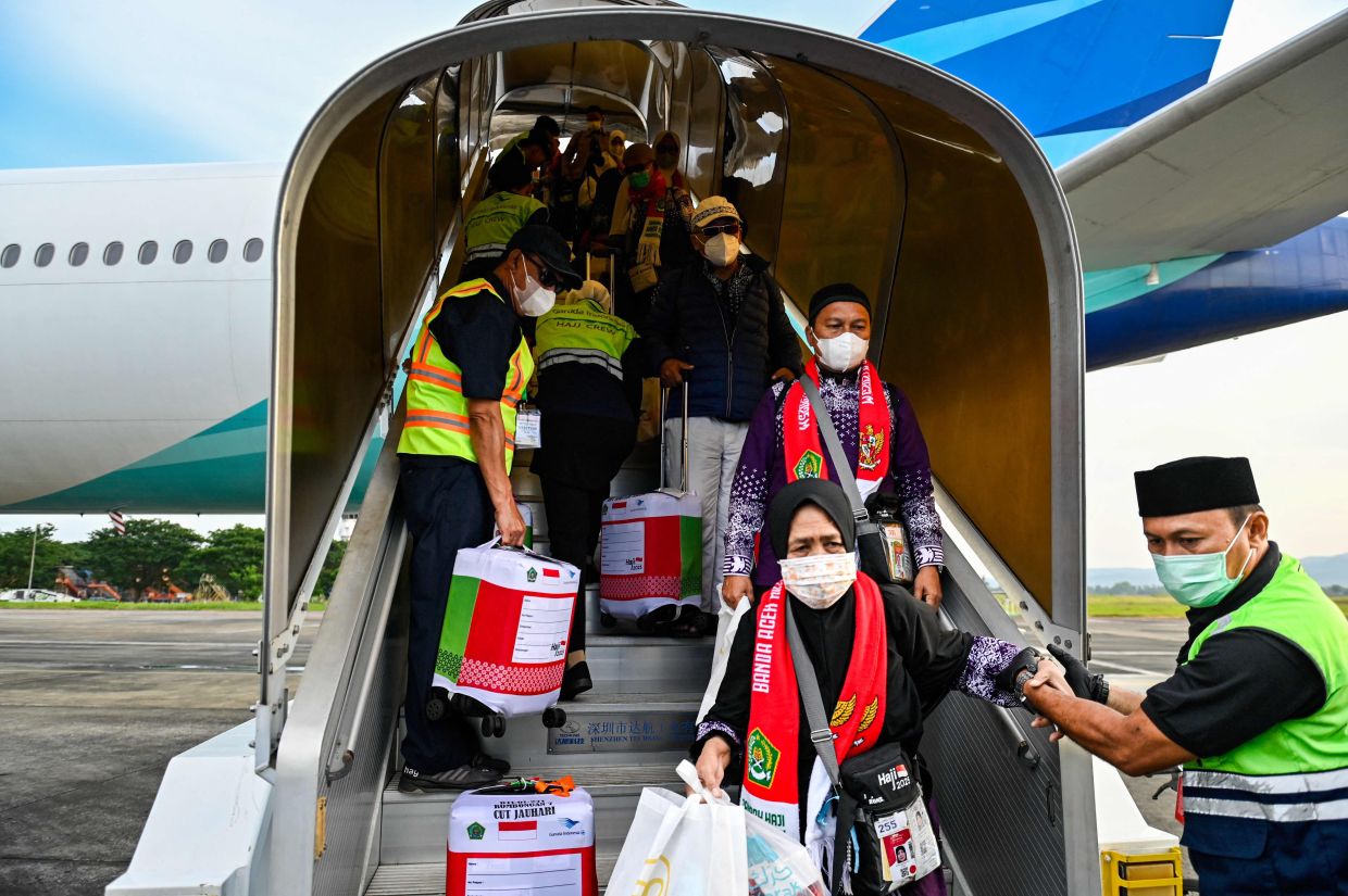 Returning pilgrims receive assistance as they disembark from their aircraft upon arrival at the Sultan Iskandar Muda International Airport in Blang Bintang, Aceh province on Saturday, June 28, 2025, after performing the annual Haj pilgrimage. -- Photo by CHAIDEER MAHYUDDIN / AFP