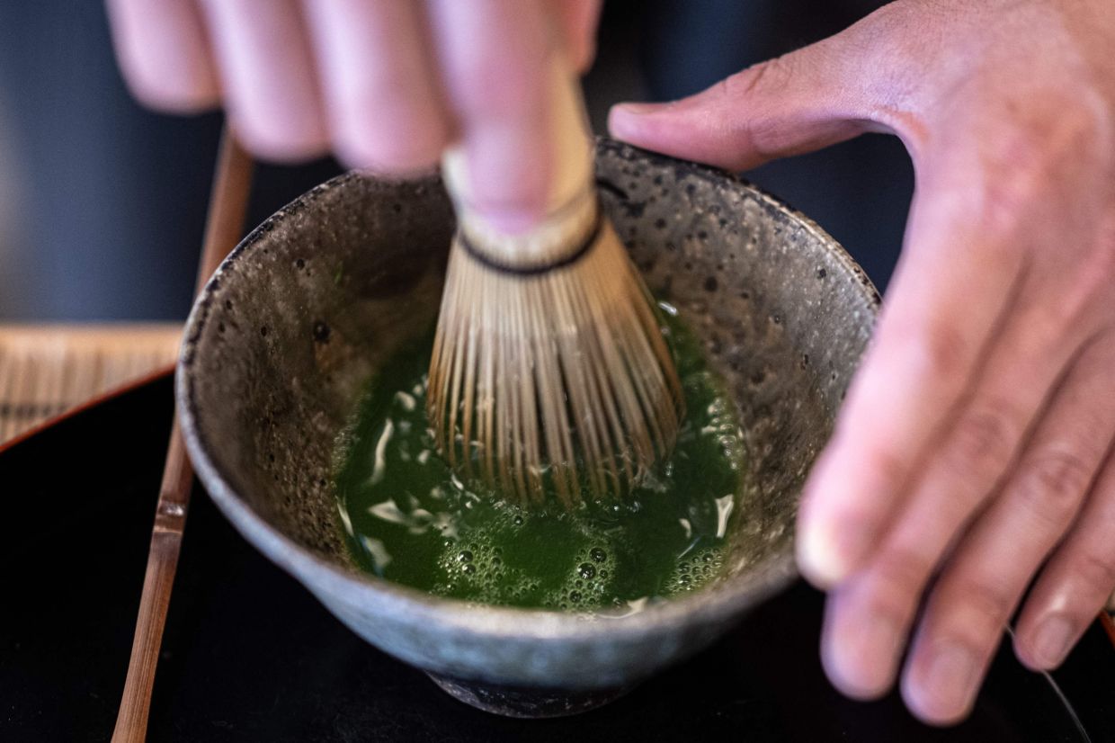 The manager of Jugetsudo tea store Shigehito Nishikida making a bowl of matcha, in the shop of Tokyo's Tsukiji area. — Photo by Philip FONG / AFP