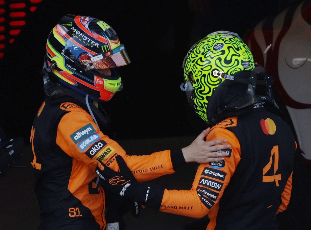 Formula One F1 - Austrian Grand Prix - Red Bull Ring, Spielberg, Austria - June 29, 2025McLaren's Lando Norris celebrates after winning the Austrian Grand Prix with second place driver and teammate Oscar Piastri, also of McLaren. -- REUTERS/Leonhard Foeger