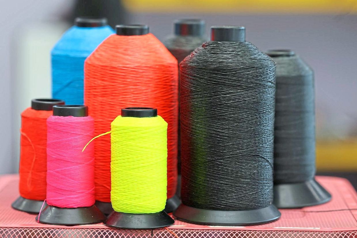 High-performance bowstring fibres in vibrant hues, ready to be spun into precision and power.