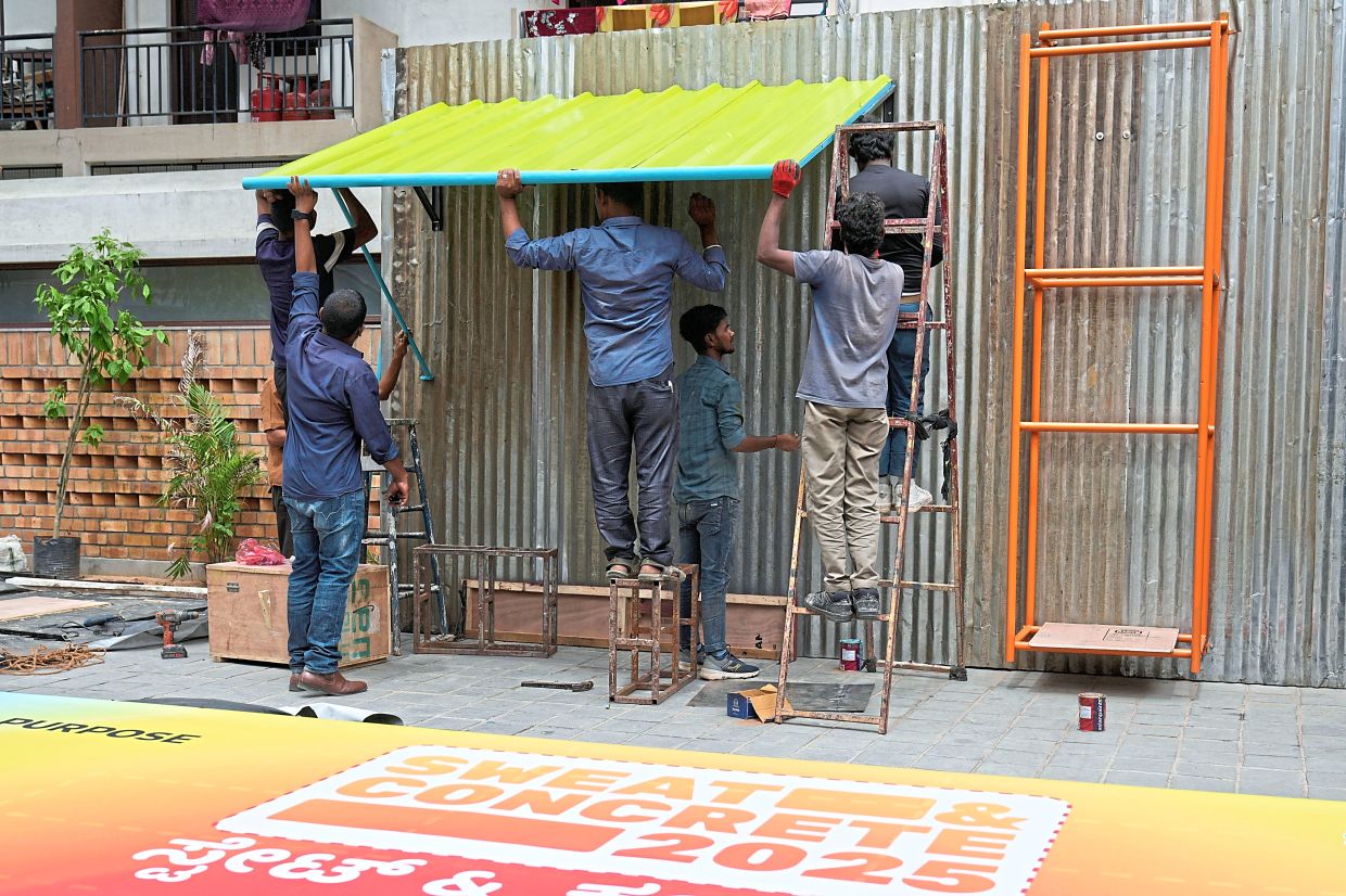 Workers installing Neralu, an innovative portable heat shelter, ahead of the Sweat and Concrete 2025 event in Bengaluru, which showcased challenges and solutions to heat stress in the city. — AP