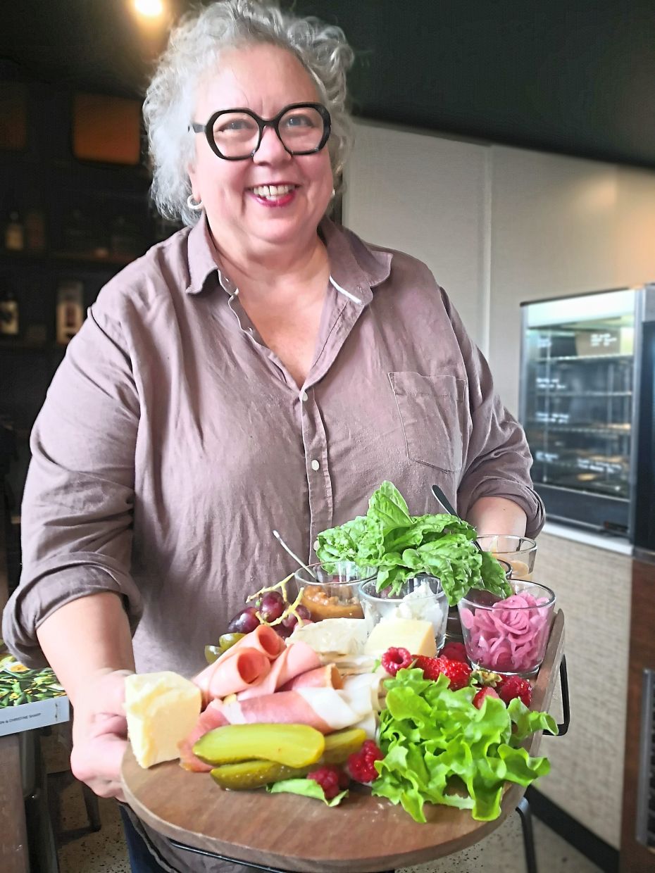 Brenda with a wide selection of Scenic Rim fresh produce at Picnic Real Food Bar.
