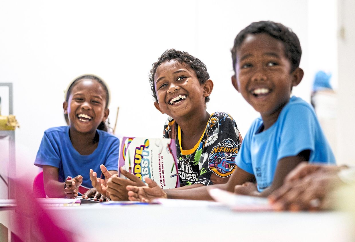 (From left) Orang Asli pupils Amira Hasaan, Adham Hani and Nasri Zainal during class at SK Sungai Tiang. — Photos: Bernama