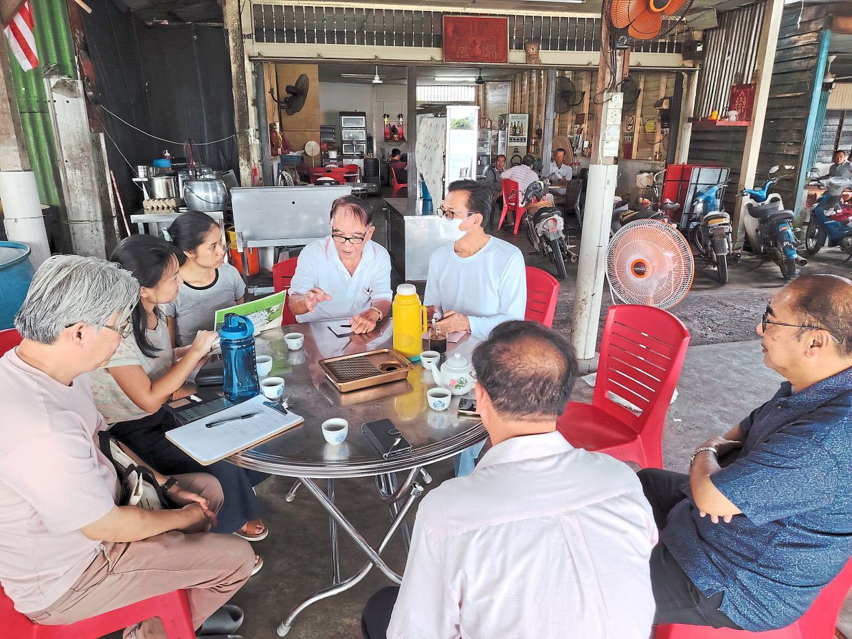 Project members recording oral history over drinks with community leaders of Nibong Tebal at an eatery along the Sungai Udang Jetty.