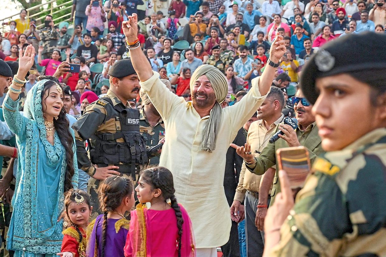 Bridging the gap: Bollywood actors Sunny Deol (centre) and Ameesha Patel (left) attending a promotional event for their film ‘Gadar 2’ at the India-Pakistan Wagah border post in 2023. With Pakistan producing just a handful of movies each year under strict censorship rules, Bollywood has always proven popular among viewers. — AFP