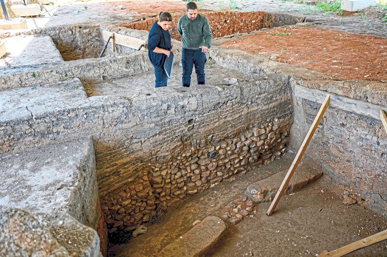 Sari and Turkteki inspecting an ancient house at the Kulluoba excavation site in Eskisehir province.