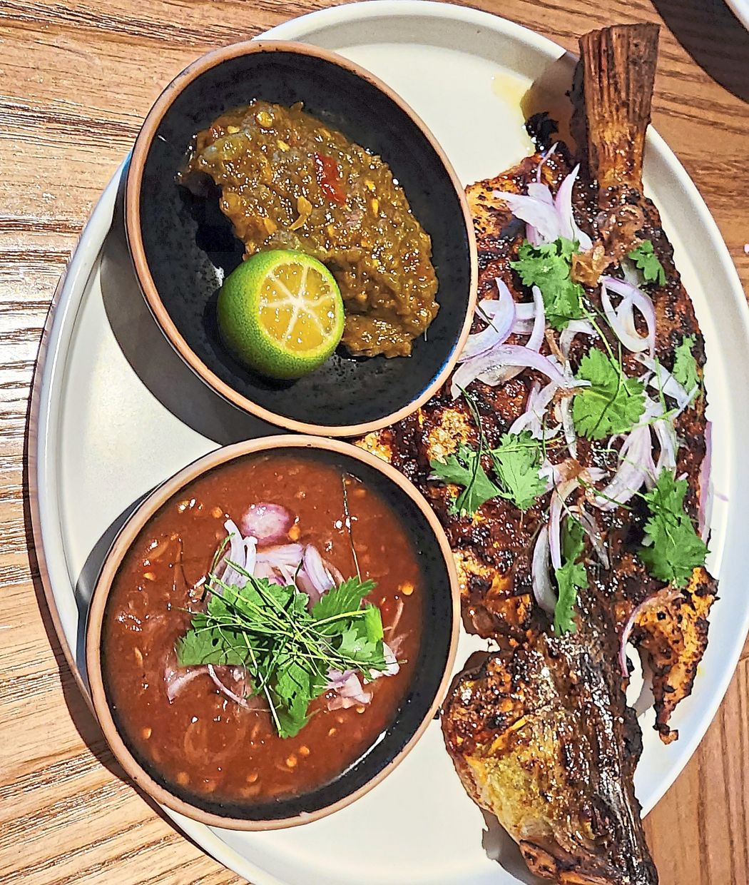 Ikan bakar is given the goddess treatment here and emerges with charred skin, supple flesh and two spicy, fiery sidekicks to boot.