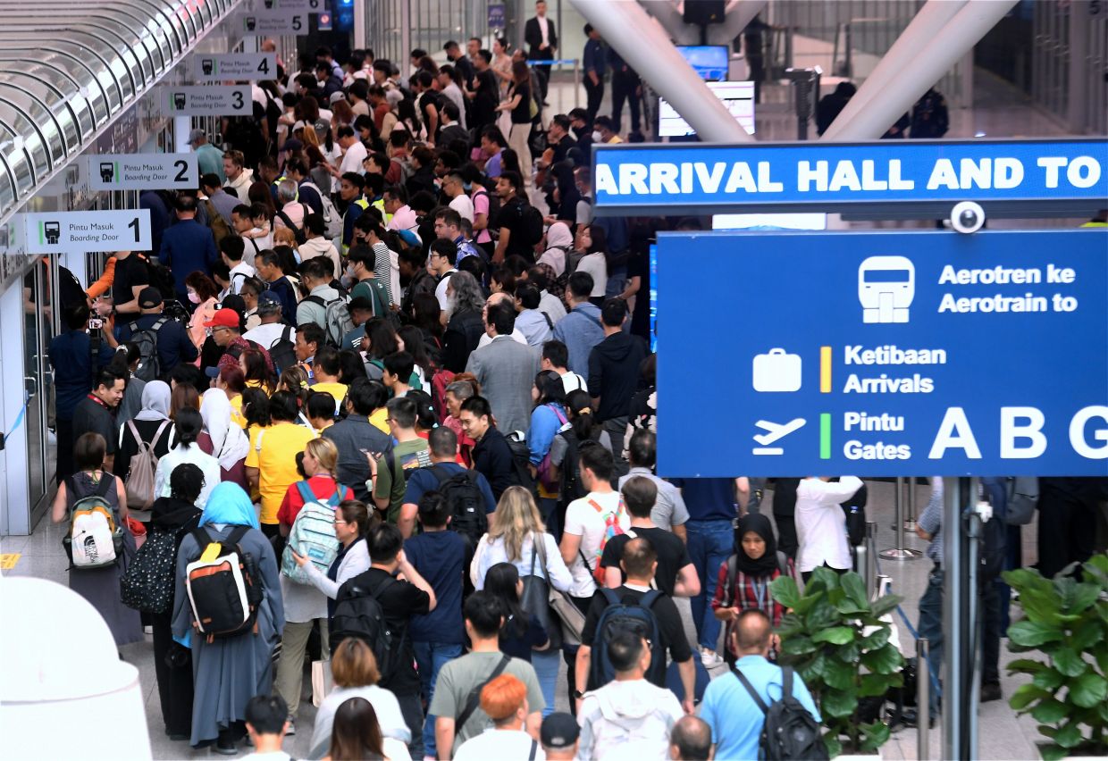 Travellers waiting to board the aerotrain at KLIA Terminal 1 as it resumes service after more than two years of suspension due to frequent breakdowns. — AZHAR MAHFOF/The Star