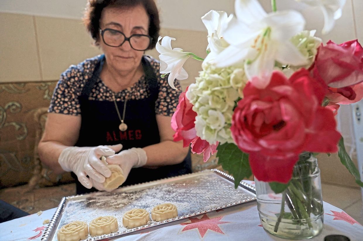 Odeta Nasi prepares traditional Albanian sweets with rose water in her workshop.
