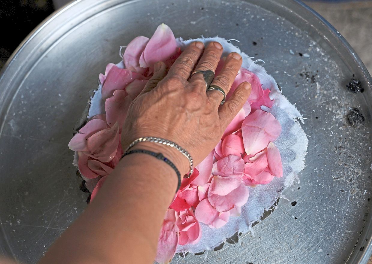 Nikolla prepares rose water.