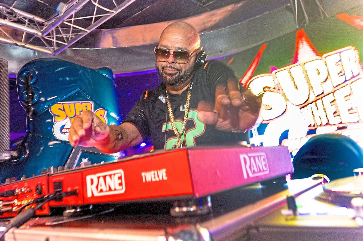 DJ Laz on the turntables during a skating party at Super Wheels.