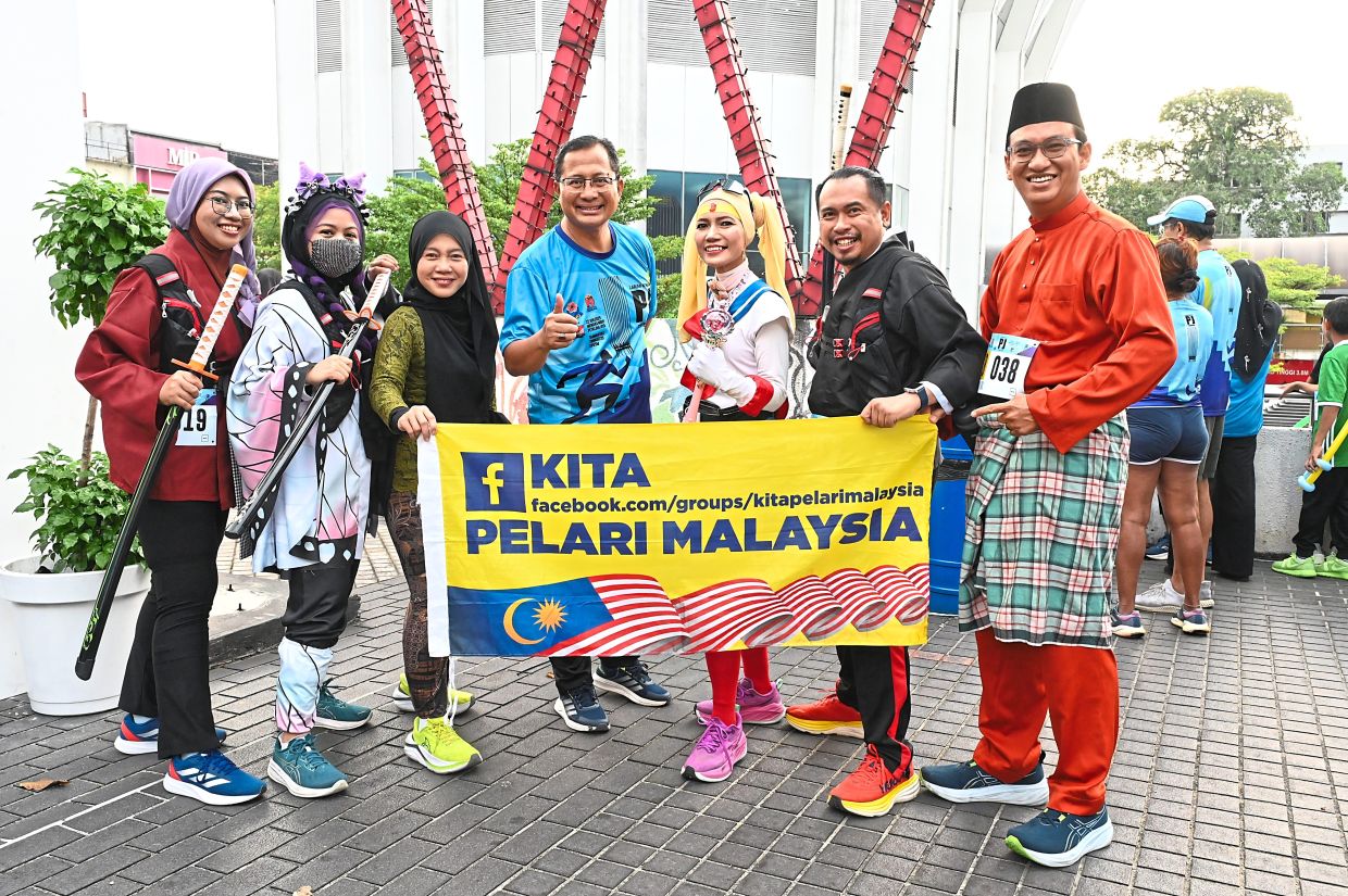 Mohamad Zahri (centre) posing with cosplay runners at PJ Tower Run 2025.