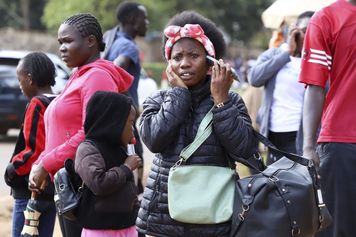 A woman talks on her mobile phone in downtown Nairobi, Kenya. In Africa, where only 37% of the population had Internet access in 2023, according to the International Telecommunication Union, regular mobile calls are the only option many have.
