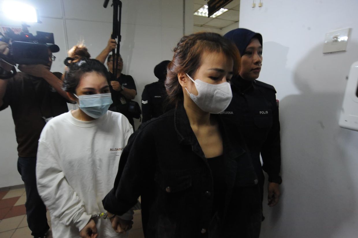 Vietnamese Pham Thi Quy, 26, (left) and Nong Thi Nhinh, 29, being led into the Magistrate’s Court in Johor Baru on July 3, 2025.