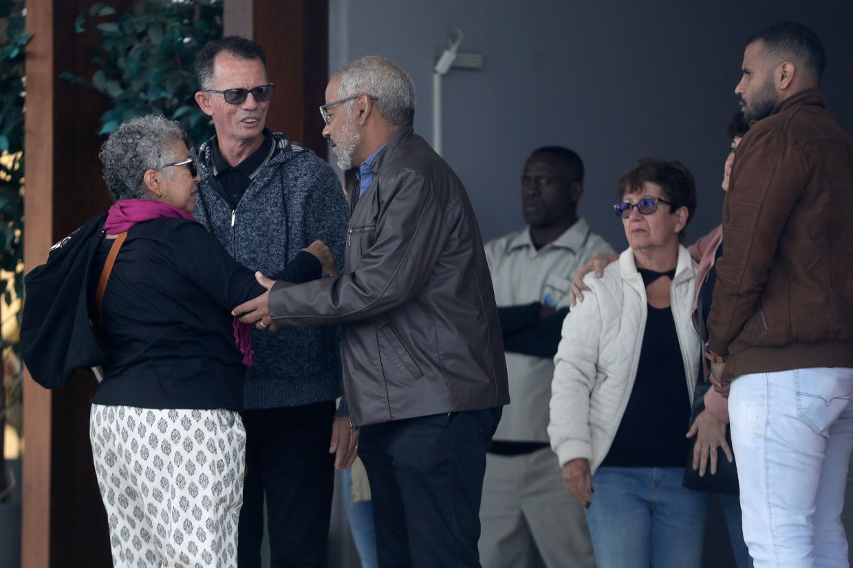 Manoel Marins, center, and Estela Marins, left, meet with friends during the funeral for their daughter Juliana Marins, who died after falling from the summit of Mount Rinjani in Indonesia, at Parque da Colina cemetery in Niteroi, Rio de Janeiro state, Brazil, Friday, July 4, 2025. -- AP Photo/Bruna Prado