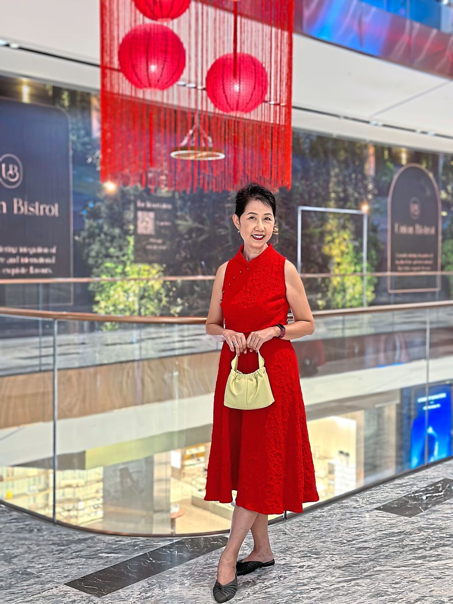 Kan turns heads with her elegant red Cheongsam. - Lilly Kan