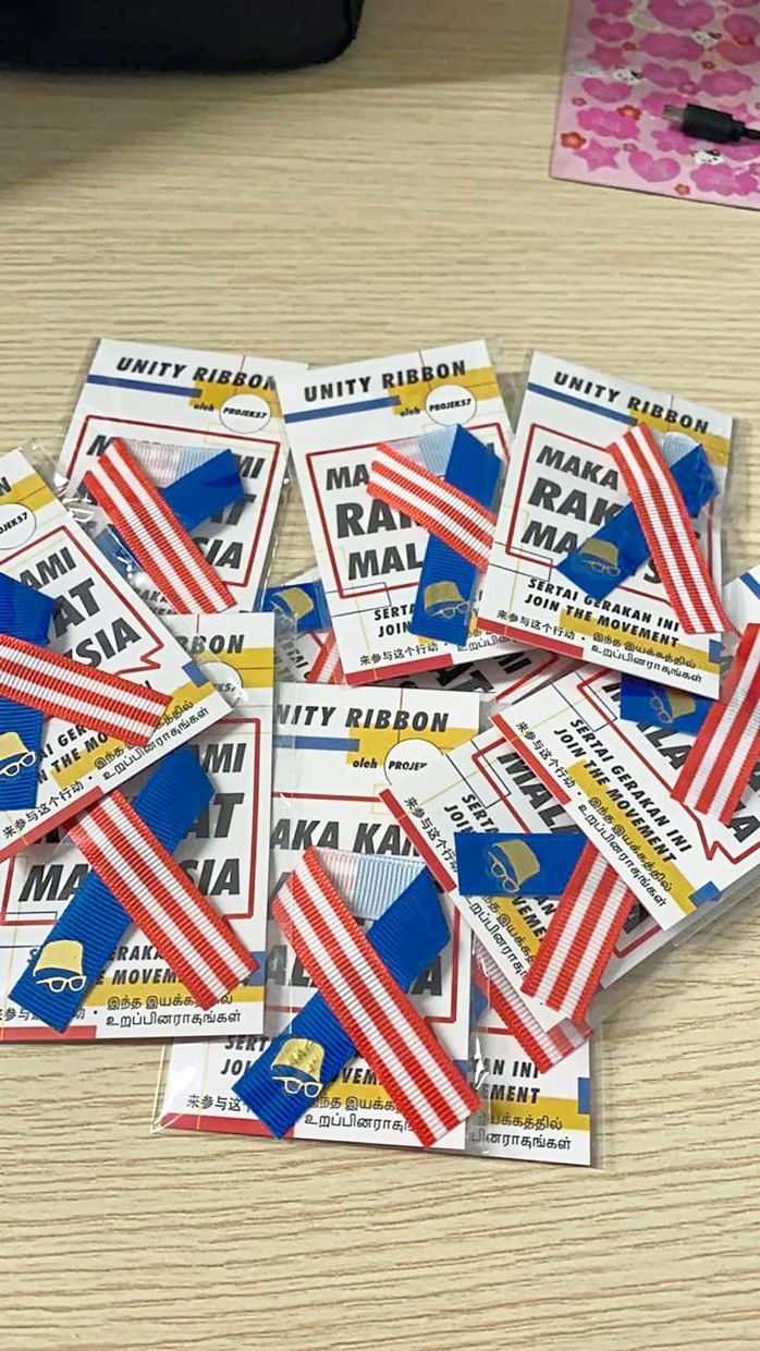 Projek57’s unity ribbon pins are used to spread the message of unity.
