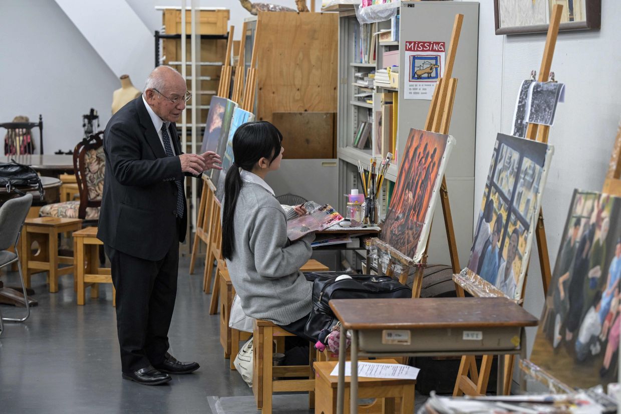 Atomic bomb survivor Masaki Hironaka (left) shares his experience with a student, recounting the events of Aug 6, 1945, as part of a testimony project at Hiroshima’s Motomachi High School. Photo: AFP