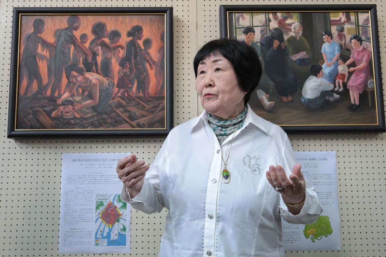 Atomic bomb survivor Tomoko Wakimasu speaks to the media at a press preview of student paintings based on survivor testimonies at Hiroshima’s Motomachi High School. Photo: AFP