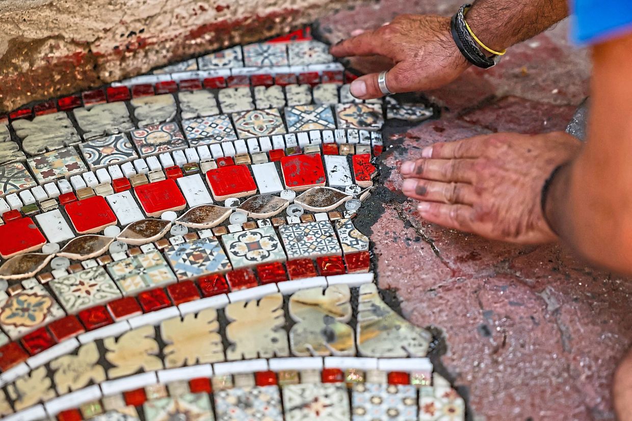 Invited by the French Institute in Ankara, Ememem installs what he calls his 'flackings,' incorporating geometric motifs in road defects. Photo: AFP 