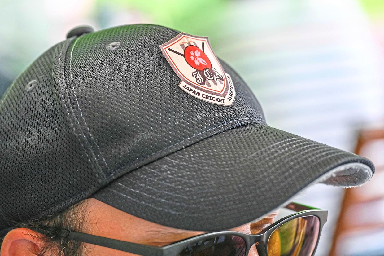 A fan wearing a cap of the Japan Cricket Association during the women’s Sano City International Trophy match.— AFP