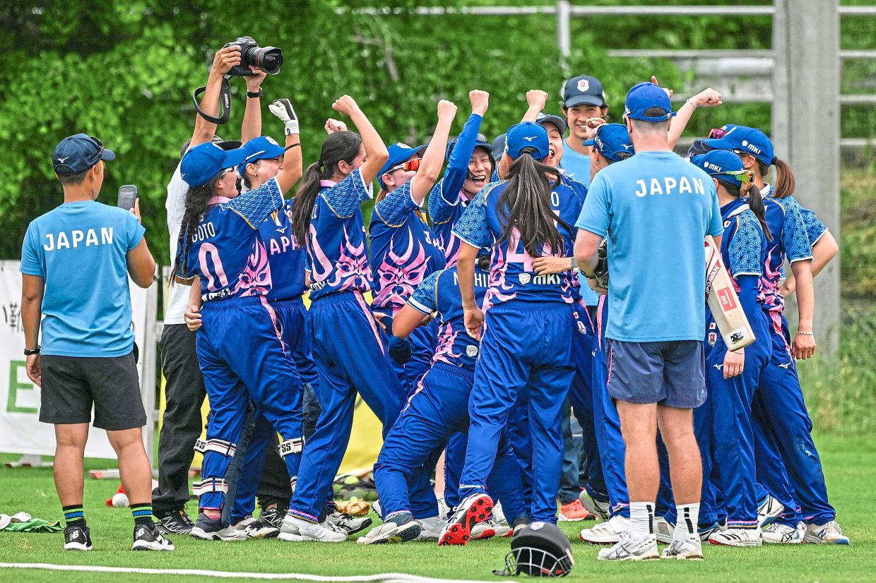 Japan cricketers gathering prior to the start of the match against Hong Kong. — AFP