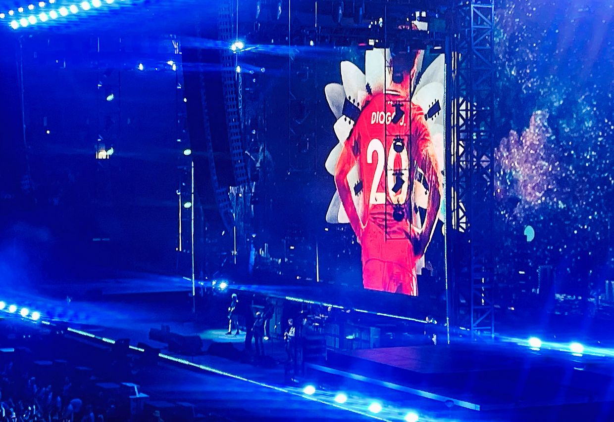 A picture of Jota is projected on a screen behind the British rock band Oasis during the first of their sellout comeback shows at the Cardiff Principality Stadium in Cardiff, Wales, on July 4. — Reuters